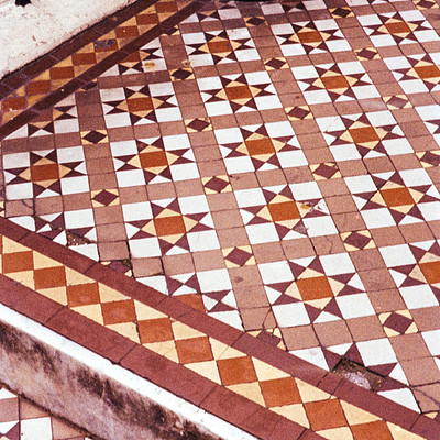 The image features a beautifully designed tile floor with a pattern of diamond shapes. The tiles are arranged in a way that creates an intricate and visually appealing design. In addition to the main diamond-shaped tiles, there are also some square tiles interspersed throughout the scene.